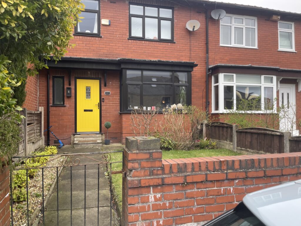 Front garden with wall, path and lawn before a driveway conversion