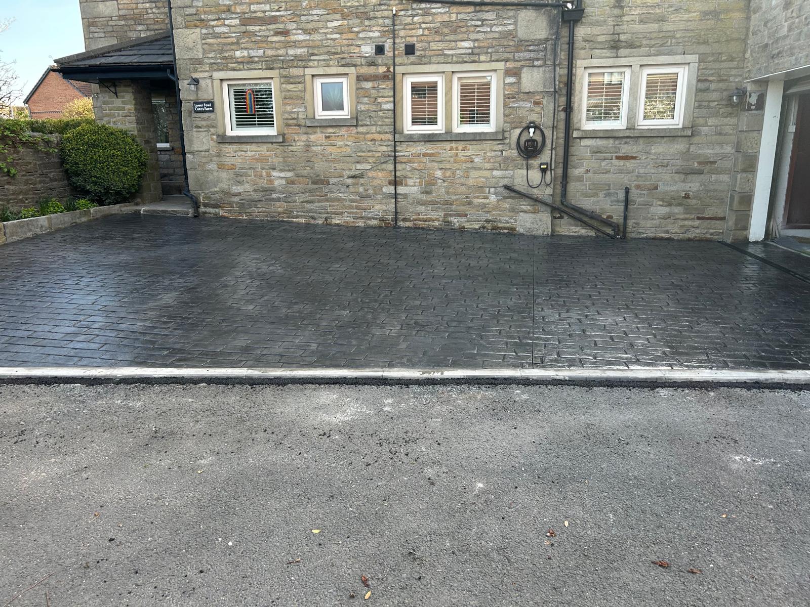 New charcoal pattern imprinted concrete driveway Ramsbottom for three cars