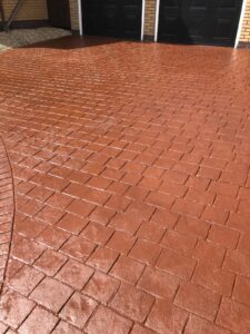 Red concrete driveway after re-sealing - sealant applied