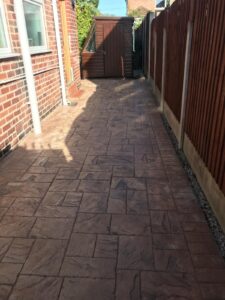 Brown tile printed concrete driveway before re-seal